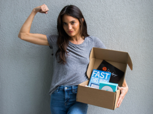 Woman holding the Dave Asprey Box Spring 2021 Fast This Way