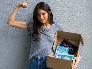 Woman holding the Dave Asprey Box Spring 2021 Fast This Way