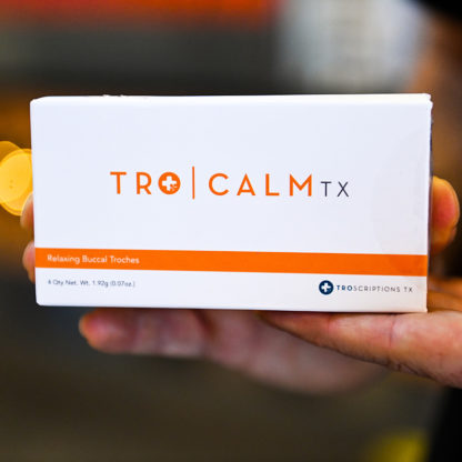 Man holding Tro Calm RX supplements